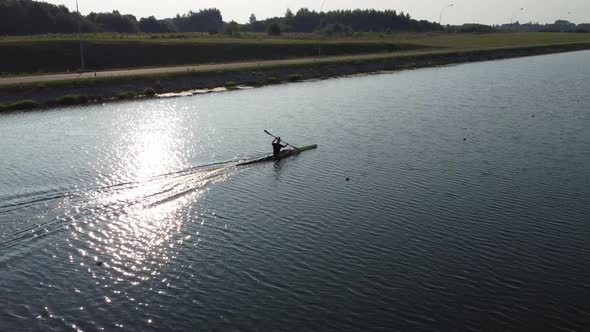 Aerial view of a professional sportsman rower sailing on a rowing canal in a kayak