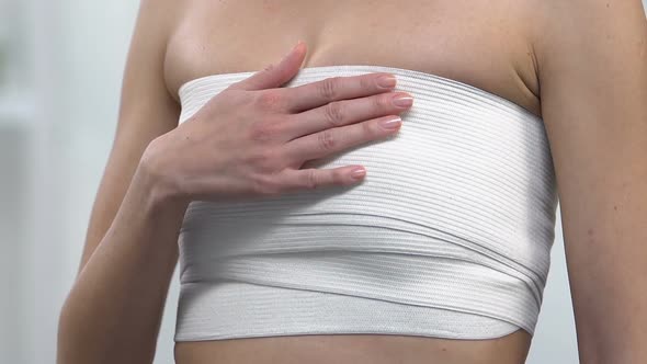 Woman Wrapped in Elasto-Fit Breast Touching Chest, Painful Surgical Suture