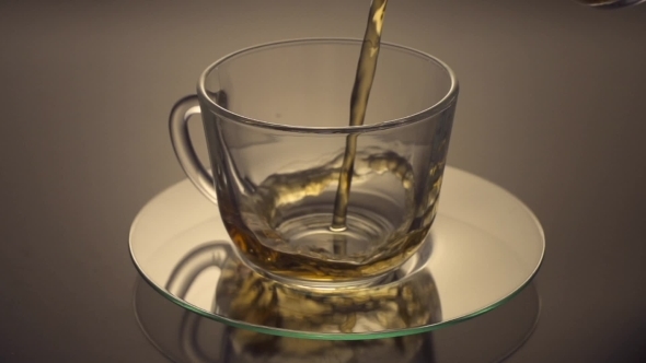 Tea Being Poured Into Glass Tea Cup
