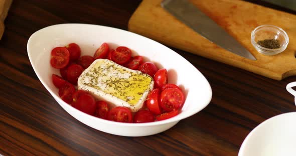 Step by step woman cooking feta cheese pasta, take a baking dish.