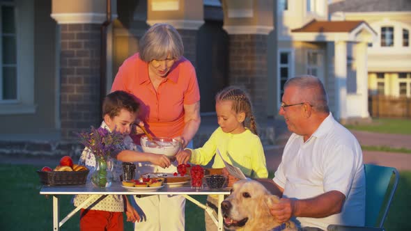 Kids Helping Grandmother to Set Picnic Table