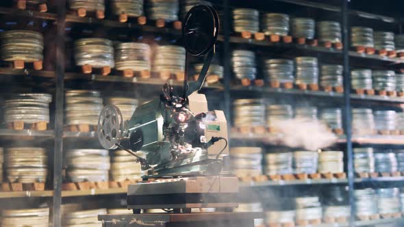 Antique Movie Projector in the Clouds of Smoke