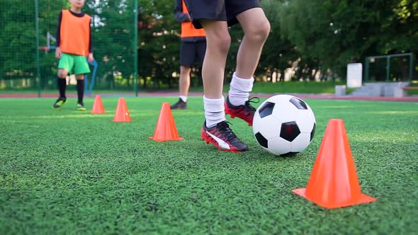 Boy's Feet that Running with Ball Around the Racks