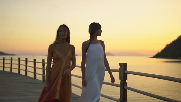 Two Lovely Caucasian Young Woman Walking on the Pier in the Evening They Having a Vocation in