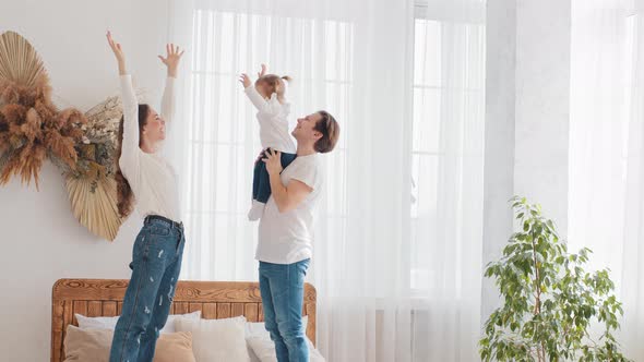 Parents Young Married Couple Caucasian Family Father Holding Little Daughter Baby Girl Lifts Up in