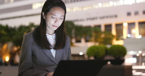 Business Woman Use of Laptop Computer at Night