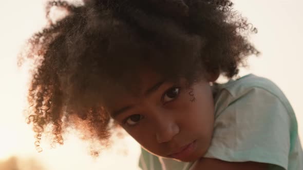 A beautiful afro-american girl is looking to the camera