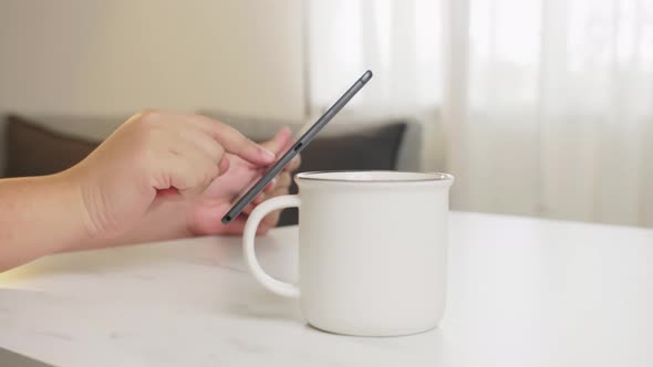 Man relaxing by surfing the internet with his digital tablet.