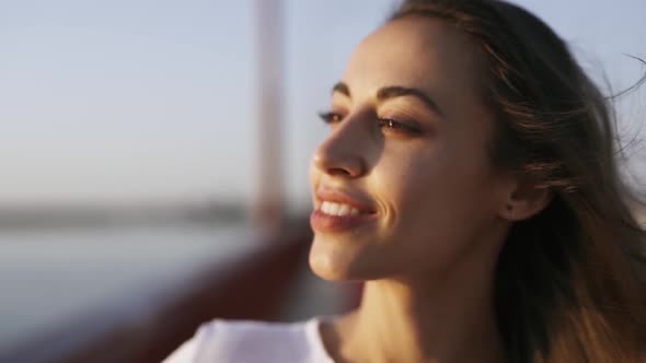 Closeup Face of Young Pretty Woman Enjoying Peaceful Sunset and Looking Ahead