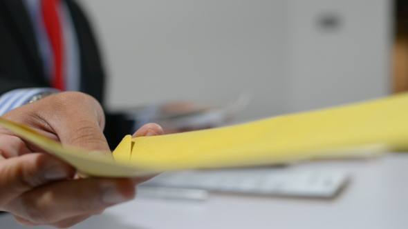 Businessman Giving Letter to His Partner alt