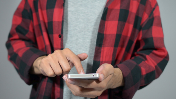 Young Casual Man's Hands on Smartphone