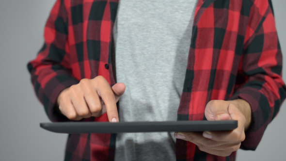 Carefree  Man Typing on Tablet Touchscreen alt