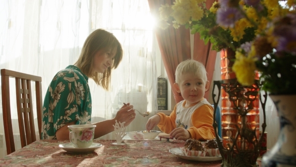 Mother Spoon-Feeding Her Son