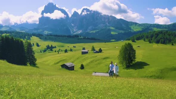 Couple Men and Woman on Vacation in the Dolomites ItalyAlpe Di Siusi  Seiser Alm South Tyrol Italy