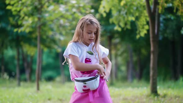 Slow motion of a girl with long hair dancing outdoors.