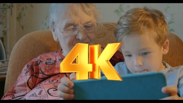 Boy Showing Something In Tablet To His Grandmother