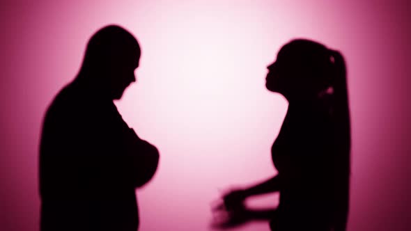 Woman Shouting on Man Quarrelling on Pink Background