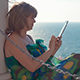 Woman Sitting On Beach By The Sea With Touch Pad - VideoHive Item for Sale