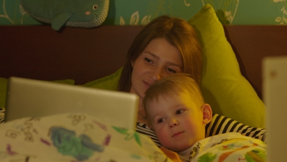 Mother And Son Watching Bedtime Cartoon In Laptop