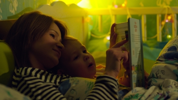 Mother And Son In Bed With Book