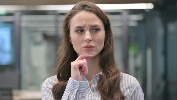 Portrait of Pensive Young Businesswoman Thinking