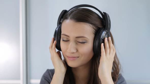 Woman Puts On, And Takes Off The Headphones