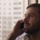 Man Talking On a Cell Phone By The Window - VideoHive Item for Sale