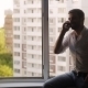 Man Talking On The Phone Sitting On The Windowsill - VideoHive Item for Sale
