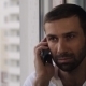 The Man At The Window Calling On The Phone - VideoHive Item for Sale