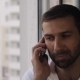 The Man At The Window Talking On The Phone - VideoHive Item for Sale
