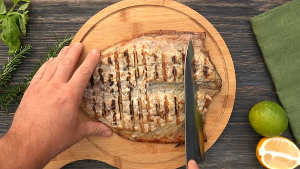 Top View of the Delicious Juicy Grilled White Fish Fillet Cut with a Knife