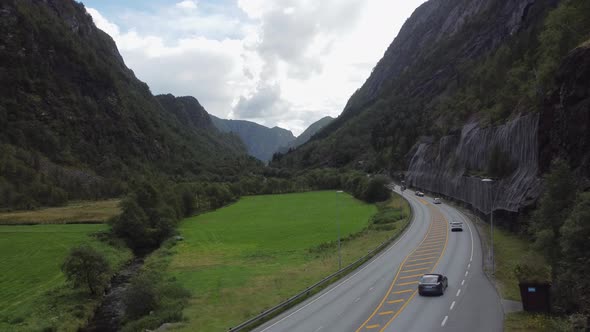 Illustration of travel and traffic in Norway - Static overview of Road E16 with passing cars - Road