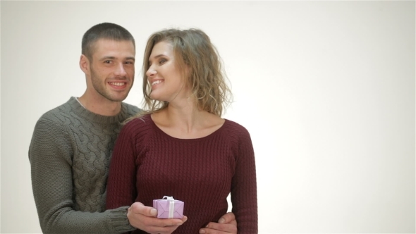 Man Embraces Girlfriend And Gives Him a Gift