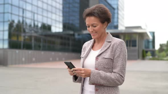 Happy Mature Businesswoman Taking Selfie In The City Outdoors