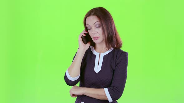 Lady Is Talking on the Phone with Her Daughters. Green Screen