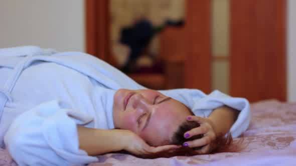 Woman Relaxing at Home on the Bed