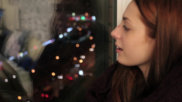 Girl Sits On Window Sill And Drinks Hot Tea In Cup