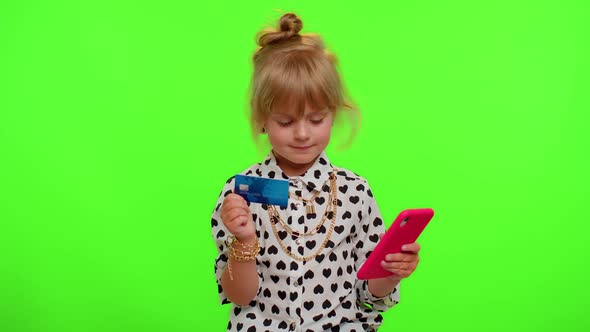 Child Kid Girl Use Mobile Cell Phone and Plastic Credit Bank Card Browsing Say Wow Yes Great Win