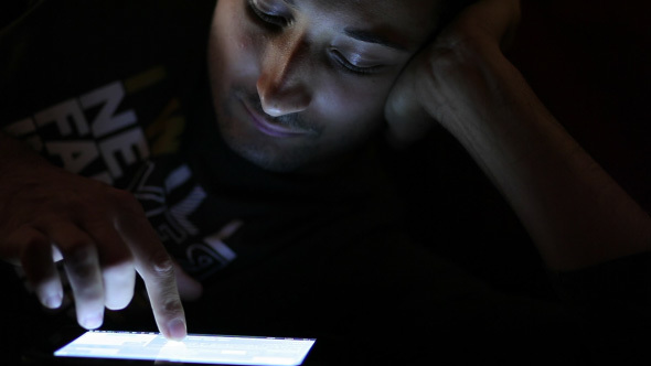 A Man Working With Tablet In Dark
