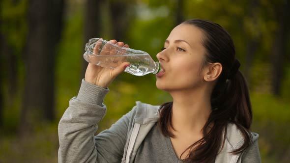 Woman Drinking Water After Sport Activities