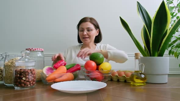 Woman Nutritionist Showing Healthy Food Plate with Vegetables Fruits Grains Nuts
