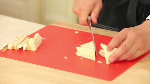 Chef Cutting White Bread Into Pieces To Cook