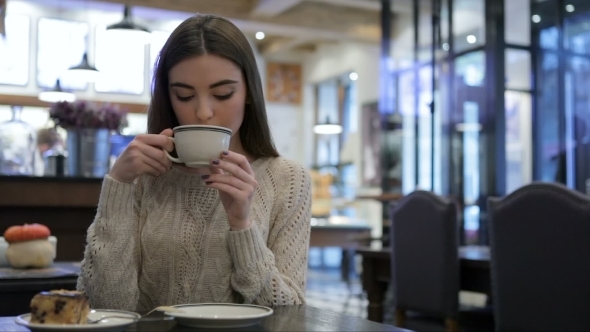 Attractive Girl Holding a Cup Of Coffee