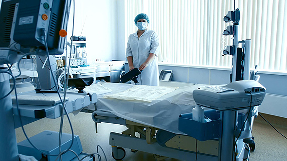 Nurse Setting Medical Equipment in Delivery Room