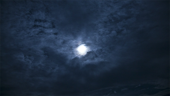 Moon Behind Moving Clouds at Night