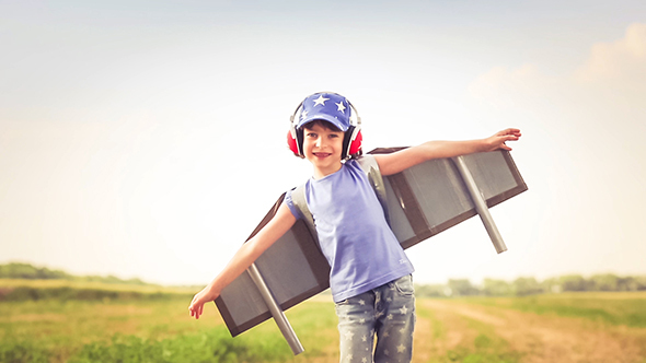 Happy Kid Playing In Summer Field