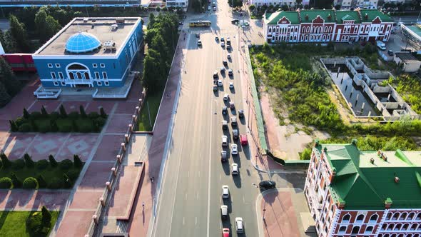 Cross roads, trees, cars during the golden hour at summer sunset. Drone footage