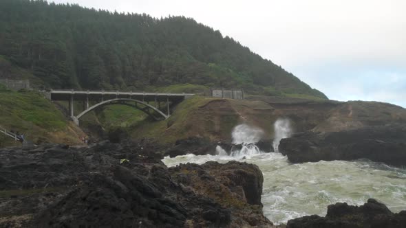 The bridge and shoreline near Thors Well on the Oregon Coast with waves crashing in the rocky inlet