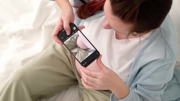 Top View Pregnant Expectant Mother Making Photo Her Big Belly on Phone