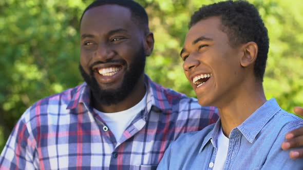 Laughing Afro-American Man Hugging Happy Son, Generations Bonding, Togetherness